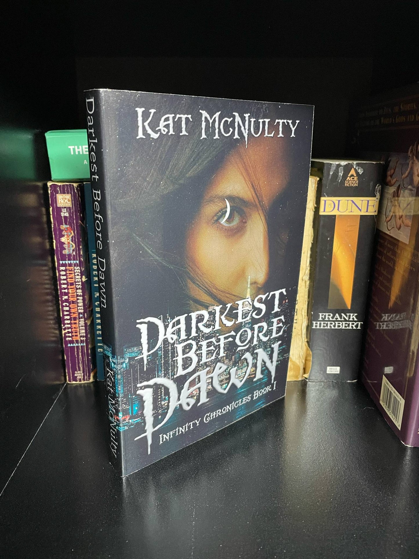 Signed paperback edition of Darkest Before Dawn by Kat McNulty
Spicy vampire romance signed book enemies to lovers
The Infinity Chronicles signed fantasy romance paperback